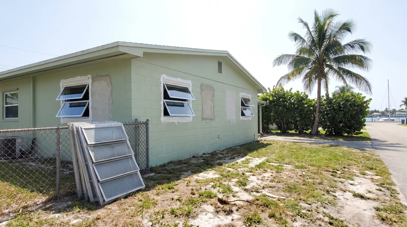 Impact windows on a mid-century concrete-block home in Dania Beach, FL