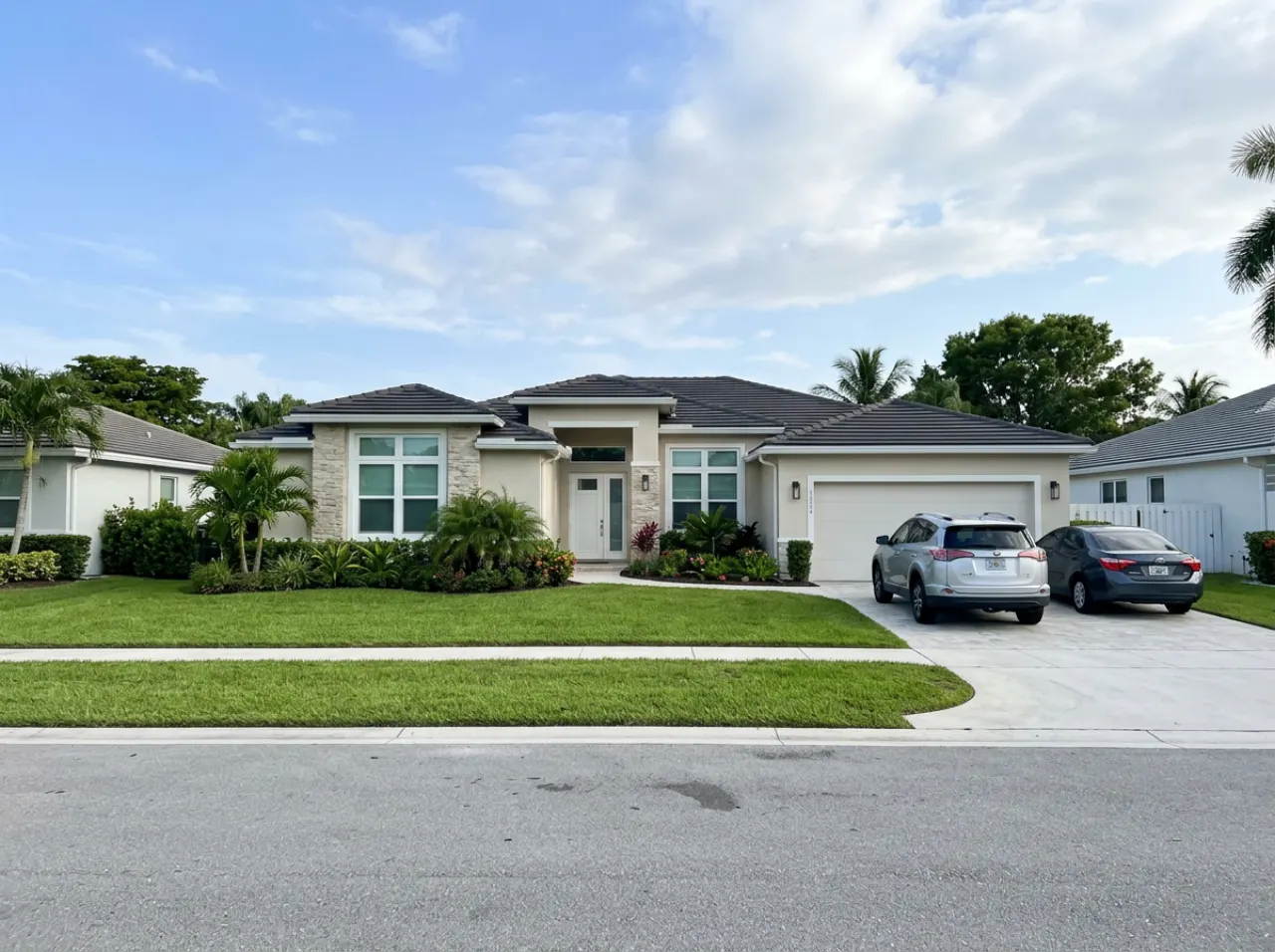 Newer suburban home with a tidy lawn in Pembroke Pines, FL