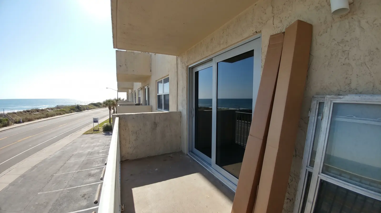 Impact sliding glass doors on an oceanfront condo balcony in South Palm Beach, FL