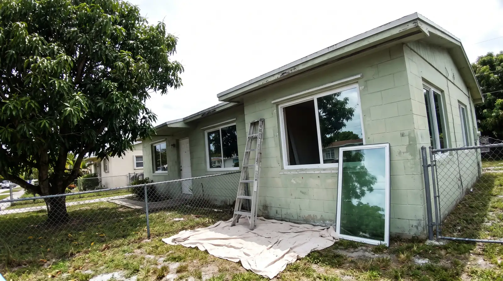 Impact windows being installed on a concrete-block home in Miami Gardens, FL