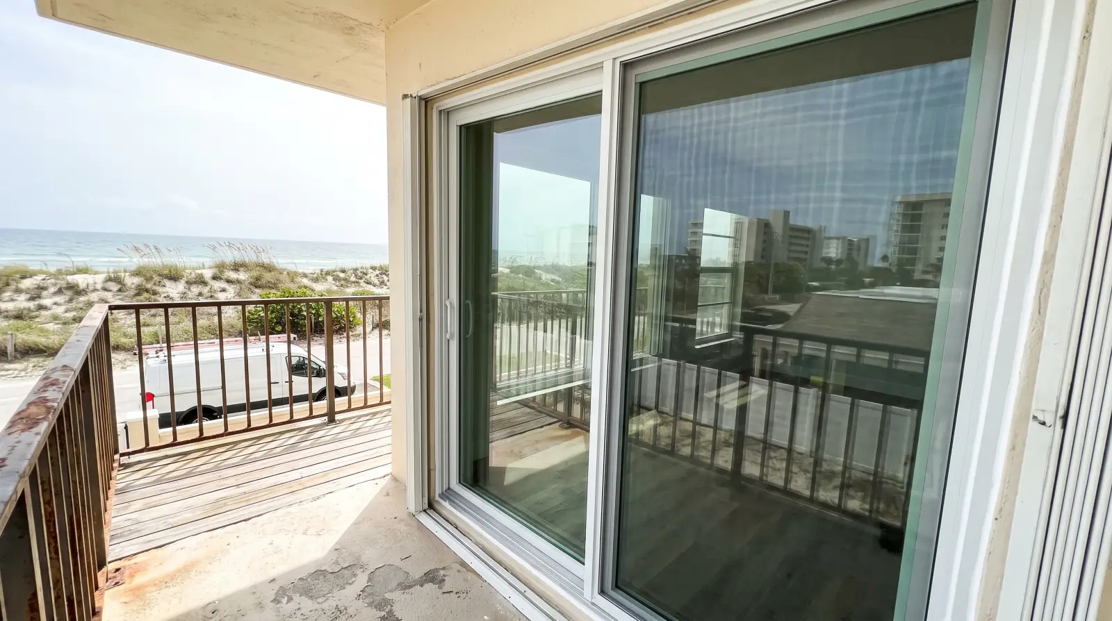 Impact sliding glass doors on an oceanfront condo balcony in South Palm Beach, FL