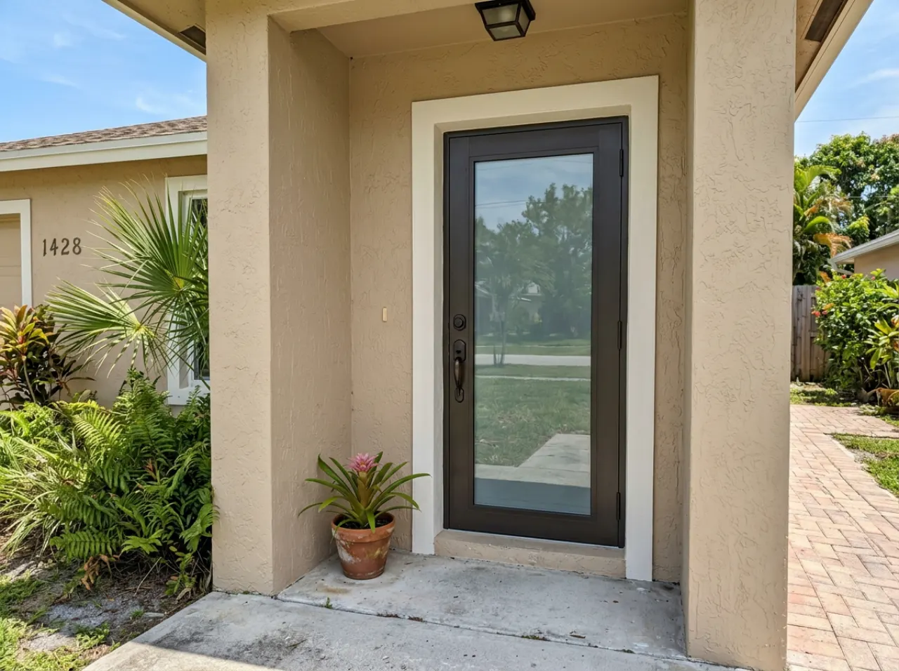 New impact front door on a South Florida home in bright daylight